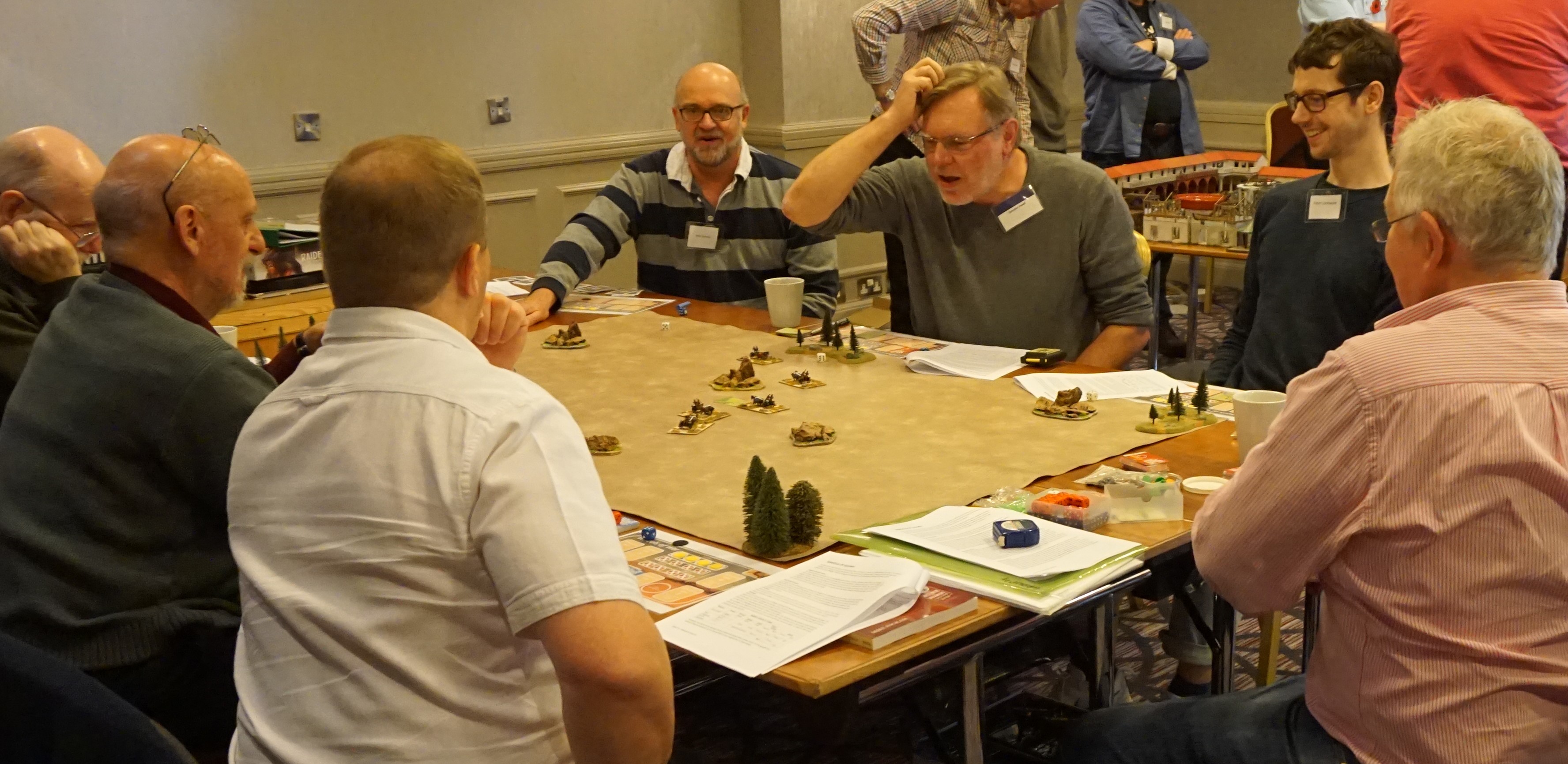 Duncan Head clutching his head over a wargaming table